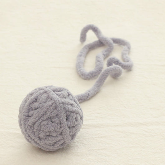 Colorful plush yarn ball cat toy in pink, blue, and white, with a long trailing strand, on a light background. - Image 3