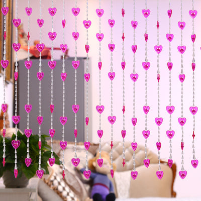 Close-up of a decorative door curtain with alternating red heart-shaped beads and clear faceted acrylic beads. - Image 14