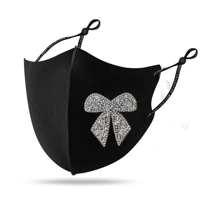 Black cloth face mask with a sparkling red and silver rhinestone bow design and adjustable ear loops. - Image 2