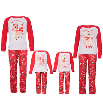 Family of five and a dog wearing matching red and white Christmas pajamas with reindeer and snowflake prints. - Image 12