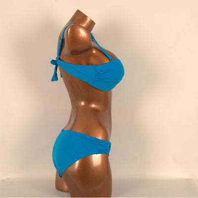 Red two-piece bikini with a twisted bandeau top and ruched low-rise bottoms, displayed on a mannequin. - Image 3