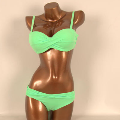 Red two-piece bikini with a twisted bandeau top and ruched low-rise bottoms, displayed on a mannequin. - Image 7