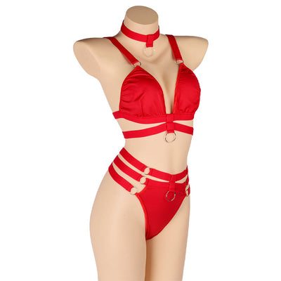 Woman wearing a royal blue strappy lingerie set with O-rings, including a bra, high-waisted bottoms, and a choker. - Image 7