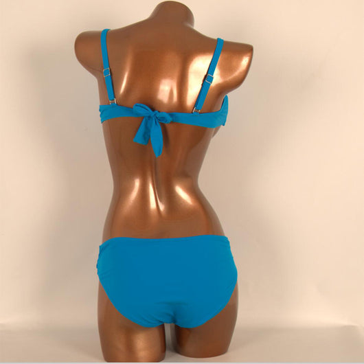 Red two-piece bikini with a twisted bandeau top and ruched low-rise bottoms, displayed on a mannequin. - Image 2