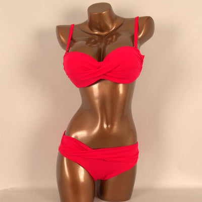 Red two-piece bikini with a twisted bandeau top and ruched low-rise bottoms, displayed on a mannequin. - Image 8