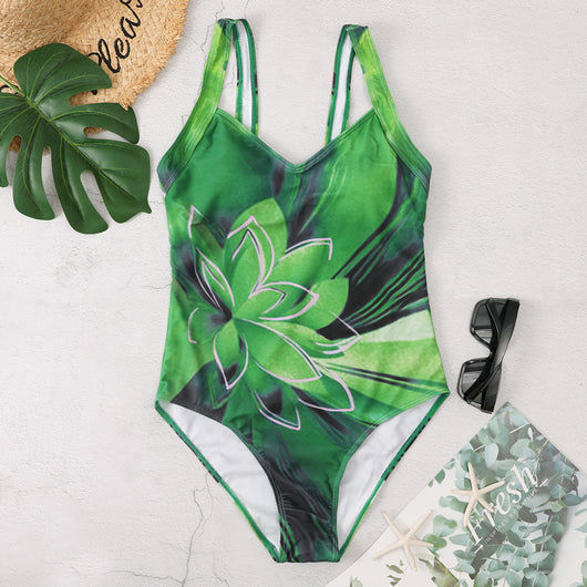 Blue one-piece swimsuit with a large light blue lotus floral print outlined in gold, featuring a V-neck and wide straps.