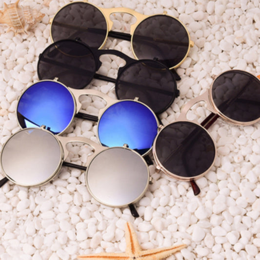 Retro flip-up sunglasses with round dark polarized lenses and a gold-tone metal frame with dark red temples.