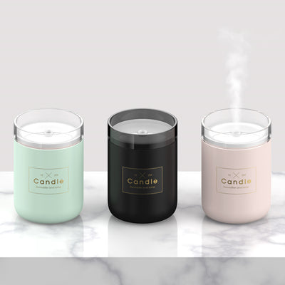 Light pink mini USB humidifier diffuser, shaped like a candle, with a clear top and visible mist output. - Image 5