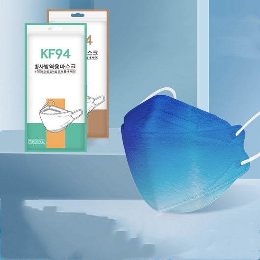 Pink gradient KF94 mask with white ear loops, displayed next to its packaging on a blue background. - Image 10