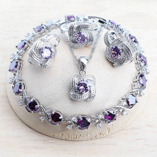 Blue zirconia jewelry set with silver-toned necklace, bracelet, ring, and earrings, featuring swirling designs. - Image 8