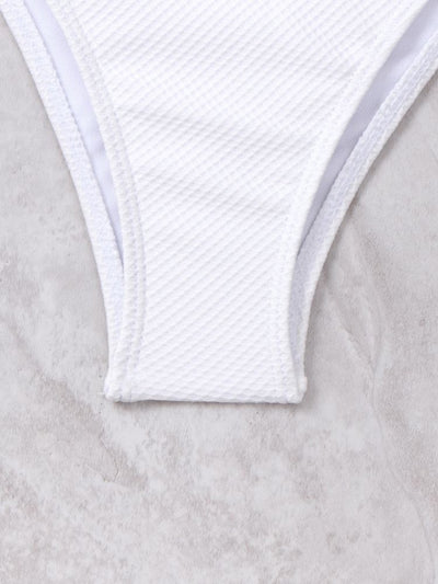 White textured two-piece bikini with a scalloped top and high-waisted bottom, worn by a woman on a sandy beach. - Image 20