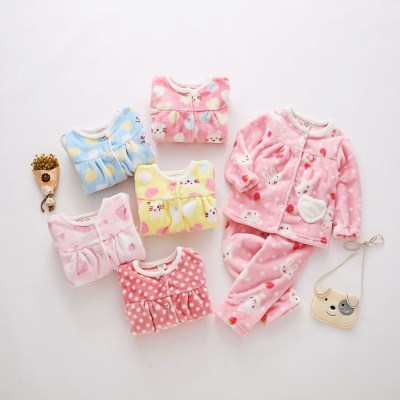 Pink flannel girls' pajamas with seashell and starfish patterns, featuring a button-up top and matching pants.