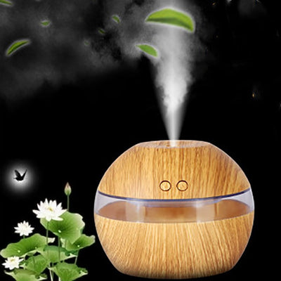 Spherical wood grain humidifier with a clear band, emitting mist, against a dark background with lotus flowers.