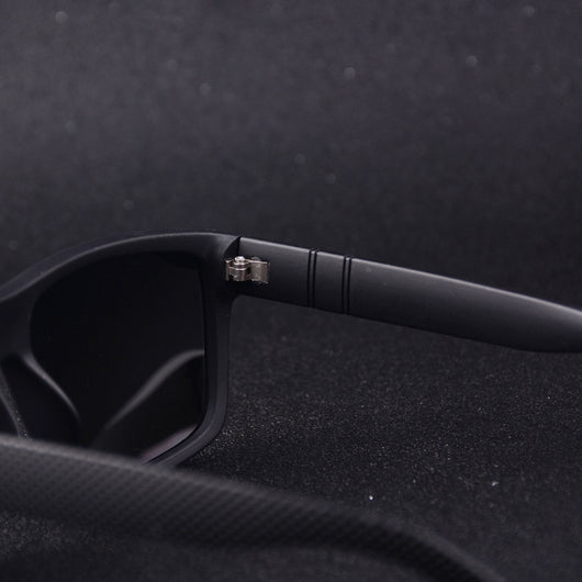 Men's grey plastic frame driving sunglasses with dark polarized lenses and red and black stripe detail on temples. - Image 2