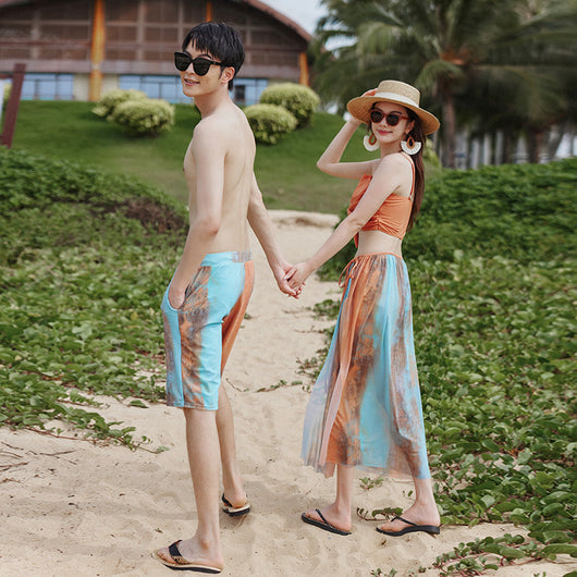 Men's or unisex swim shorts with a blue, orange, and brown abstract tie-dye print, featuring a drawstring waist and side pockets. - Image 3