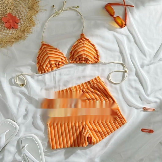 Orange and light orange striped bikini bottom with a ribbed texture and elastic waistband, ideal for beach vacations. - Image 4