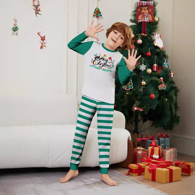 Family of four wearing matching green and white striped Christmas pajamas with "Merry Christmas" graphic. - Image 4