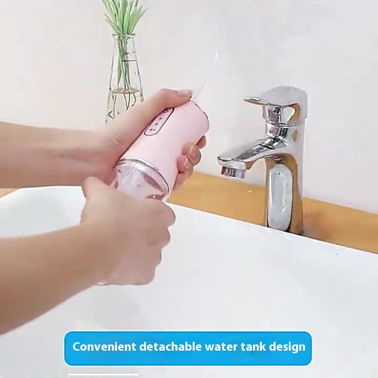 Four portable electric water flossers in green, pink, black, and silver, with clear water tanks, displayed next to their box. - Image 4