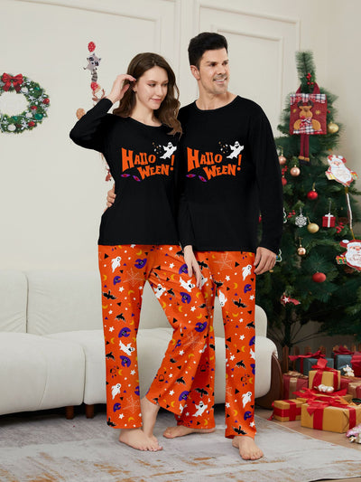 Family of four wearing matching black and orange Halloween long-sleeve pajamas with ghost and bat prints. - Image 18