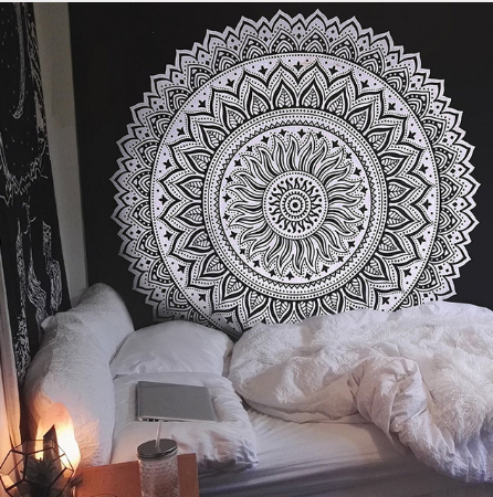 Black and white mandala tapestry with intricate geometric patterns hanging above a bed in a bedroom. - Image 4