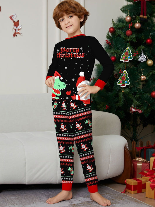 Man wearing black Christmas pajamas with a cartoon dinosaur, Santa Claus, and "Merry Christmas" text, standing by a decorated tree. - Image 14