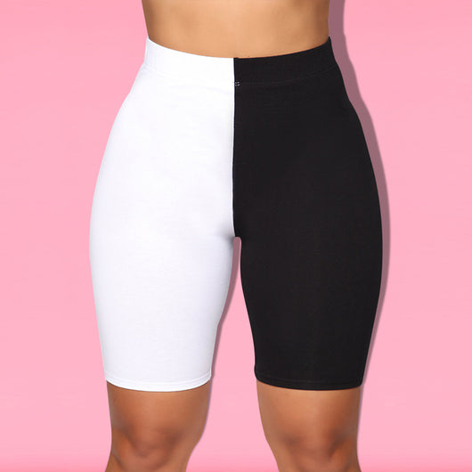 Woman wearing a black and white color-block long-sleeve top and matching shorts with white sneakers. - Image 21
