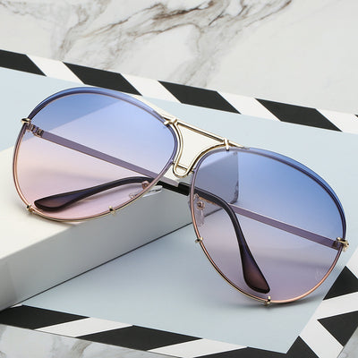 Aviator sunglasses with light blue lenses and a gold-colored metal frame, featuring a double bridge design. - Image 15