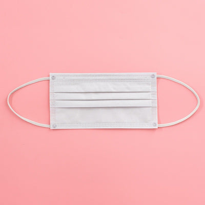 Light pink disposable face mask with white ear loops, featuring pleats for a comfortable fit. - Image 4