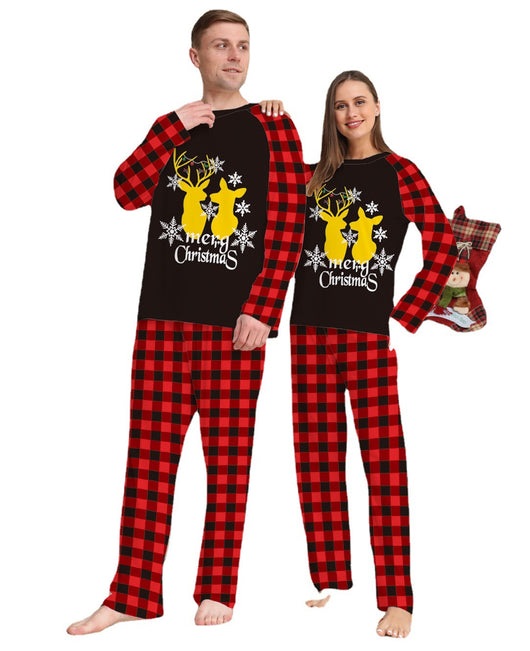 Two children in matching black and red buffalo plaid Christmas pajamas with golden deer and "Merry Christmas" print. - Image 3