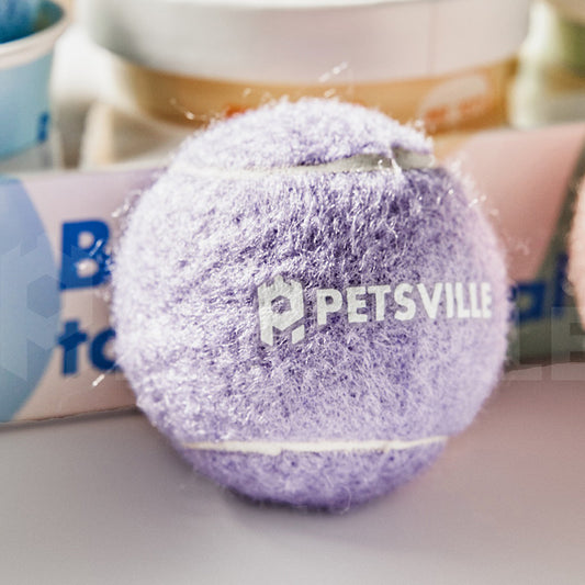 Beige Petsville tennis ball for dogs in a light yellow cylindrical container with a playful dog illustration.