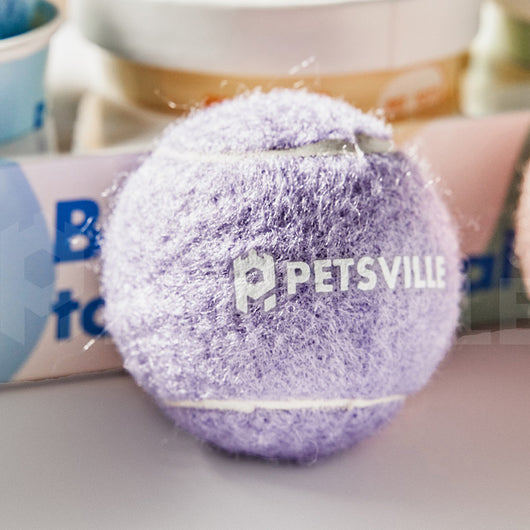 Beige Petsville tennis ball for dogs in a light yellow cylindrical container with a playful dog illustration.