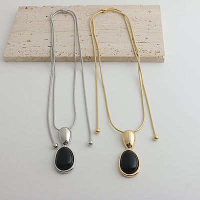 Pair of gold-toned irregular earrings with black onyx-like inserts, featuring a modern, abstract design. - Image 26