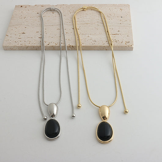 Pair of gold-toned irregular earrings with black onyx-like inserts, featuring a modern, abstract design. - Image 26