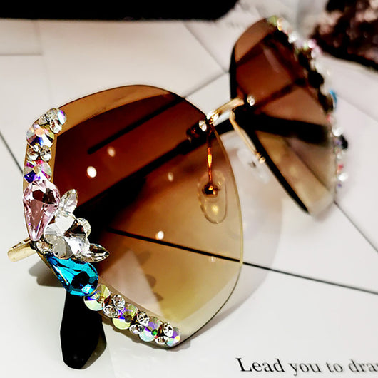 Oversized rimless sunglasses with gradient gray lenses and colorful rhinestone embellishments along the top and sides. - Image 4