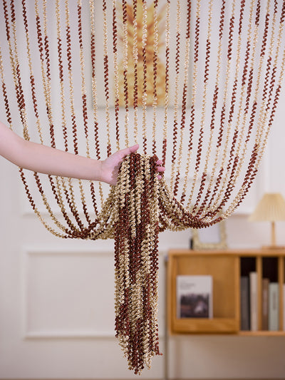 Brown and beige striped string curtain with twisted tassel texture, held by a hand, for living room partition. - Image 13
