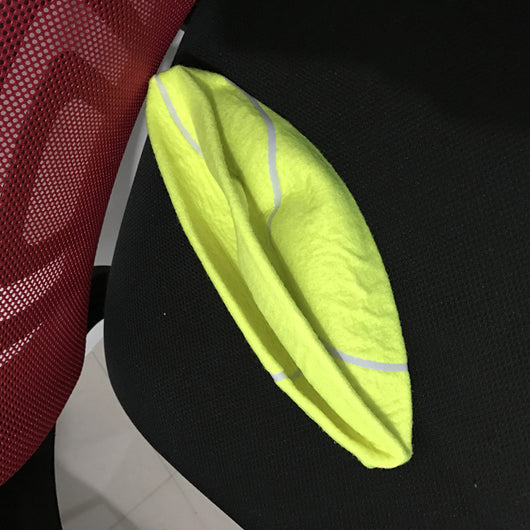 Giant yellow tennis ball with white seams for dogs, resting on a black office chair. - Image 4