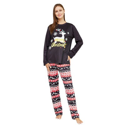 Two children wearing black long-sleeve Christmas pajamas with a "Merry Christmas" reindeer design and fair isle pants. - Image 6