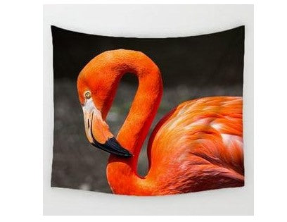 Vibrant orange flamingo cotton linen tapestry with its head tilted against a dark background.