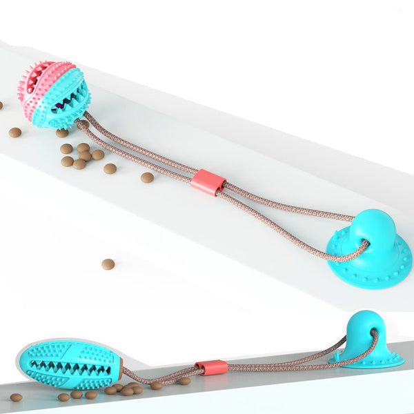 Pink and teal spiky pet molar toy with a suction cup base, designed for chewing and teeth cleaning.