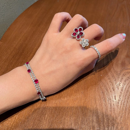 Silver-tone ring with two flower designs, one with crimson gemstones and clear zircons, the other with clear zircons. - Image 8