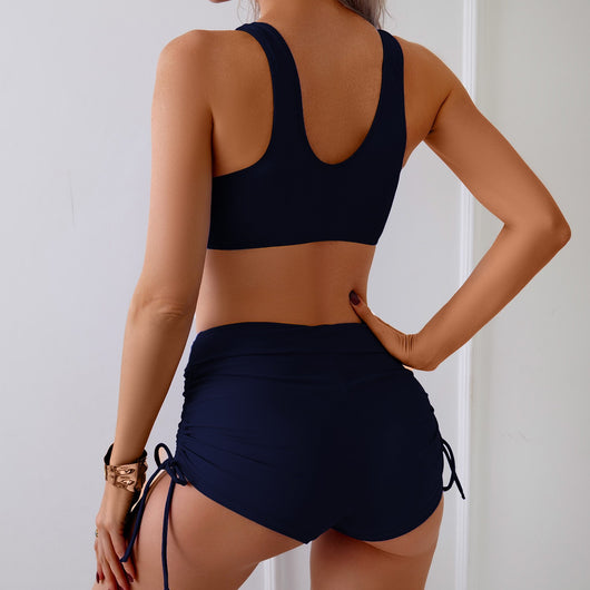 Red two-piece swimsuit featuring a criss-cross front bikini top and ruched side swim shorts with adjustable drawstrings. - Image 17