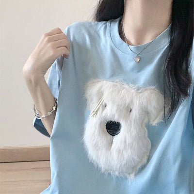 Black short sleeve t-shirt with a fluffy white puppy face embroidery, featuring a small gold barrette on its ear. - Image 3