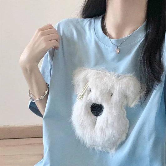Black short sleeve t-shirt with a fluffy white puppy face embroidery, featuring a small gold barrette on its ear. - Image 3