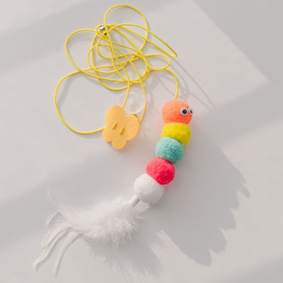 Colorful cat toy with pom-poms, googly eyes, white feathers, and a yellow elastic rope with a suction cup. - Image 15