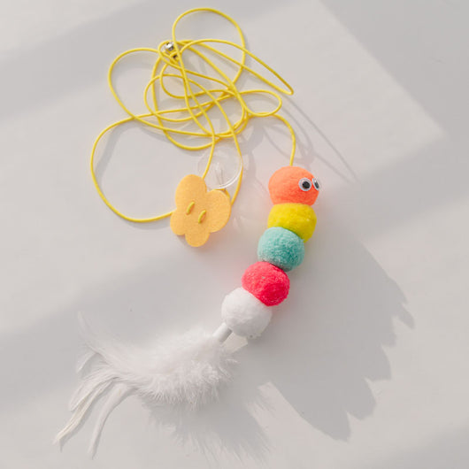 Colorful cat toy with pom-poms, googly eyes, white feathers, and a yellow elastic rope with a suction cup. - Image 15