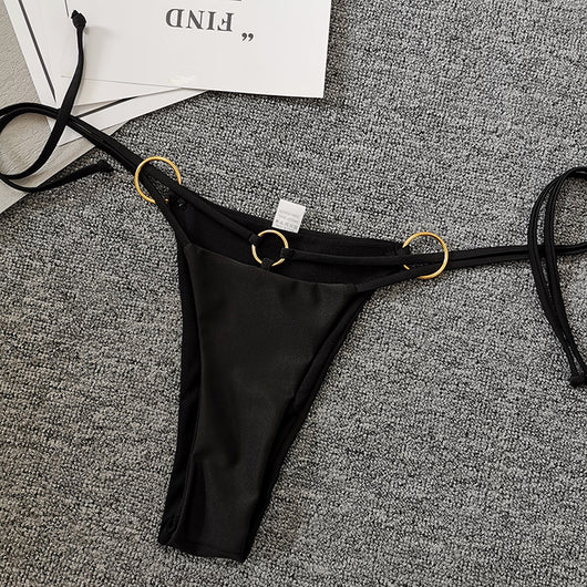 Solid black two-piece swimsuit set with a bandeau top, gold-tone O-rings, and tie straps, paired with matching thong bottoms. - Image 10