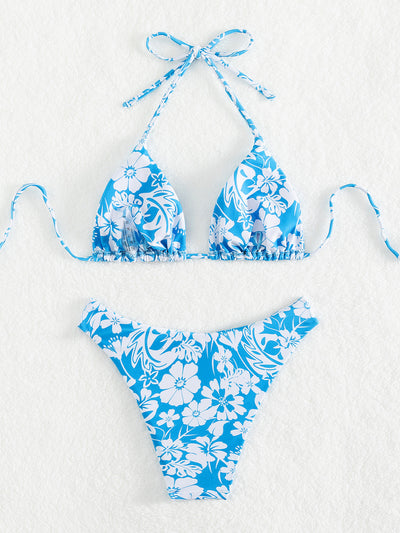 Woman wearing a black and white floral print triangle cup bikini swimsuit on a sunny beach. - Image 15