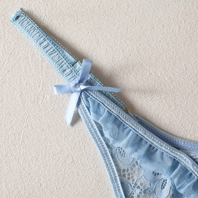 Light blue lace bralette and thong lingerie set with bow details and ruffle trim, displayed on a light surface. - Image 21