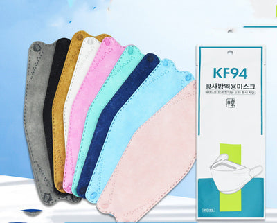 A fan of multi-colored KF94 fish-shaped masks in pink, blue, teal, white, gold, black, and grey, next to a packaged mask. - Image 17