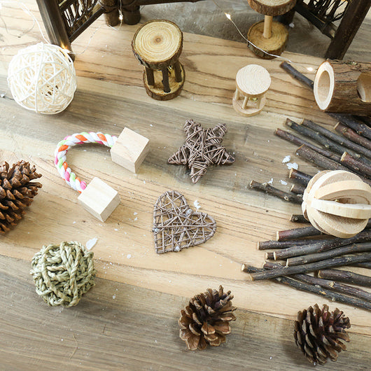 Set of natural wooden hamster toys including dumbbell shapes, a spherical bell toy, and two cylindrical bell toys, with a hamster. - Image 3